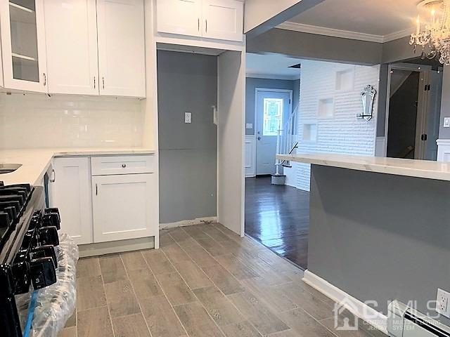 156 East Hill Road Colonia, NJ 07067 - Photo 11 of 33 an entryway with wooden floor and cabinets