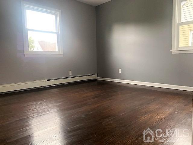 156 East Hill Road Colonia, NJ 07067 - Photo 16 of 33 an empty room with wooden floor and windows
