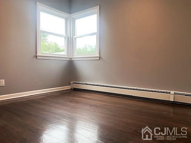 156 East Hill Road Colonia, NJ 07067 - Photo 18 of 33 an empty room with wooden floor and windows