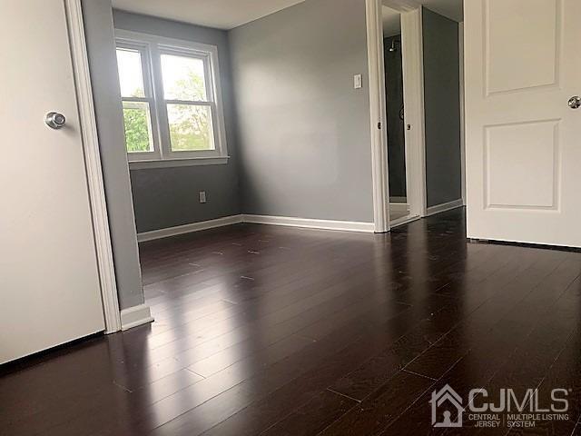 156 East Hill Road Colonia, NJ 07067 - Photo 21 of 33 an empty room with wooden floor and windows