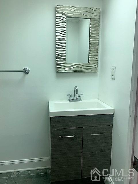 156 East Hill Road Colonia, NJ 07067 - Photo 30 of 33 a bathroom with a sink a vanity and a mirror