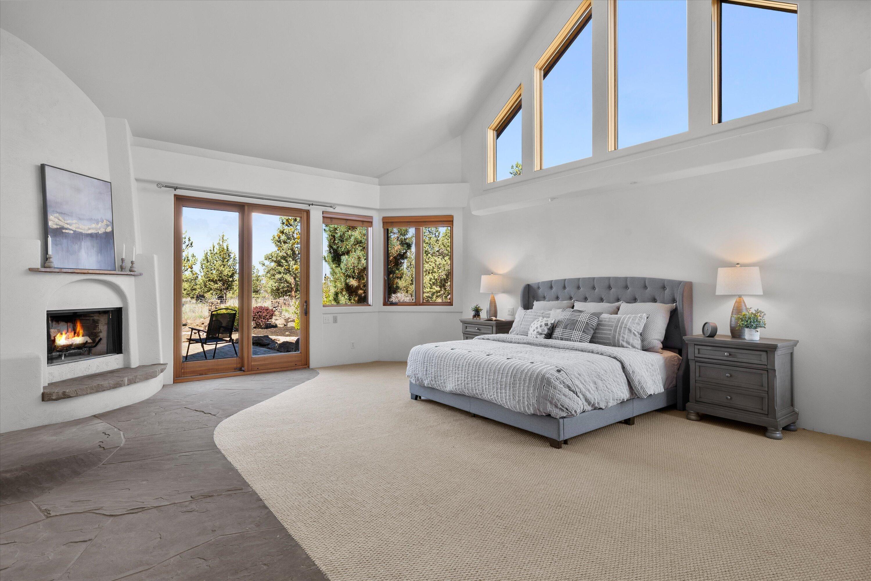 64155 Hunnell Road Bend, OR 97703 - Photo 36 of 96 Primary suite with wood burning fireplace and private patio access.