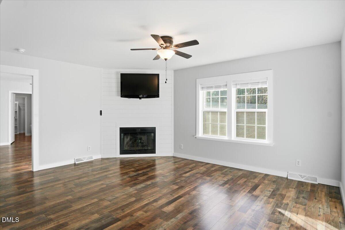 287 Moss Stock Farm Road Kittrell, NC 27544 - Photo 11 of 54 a view of empty room with wooden floor and fan