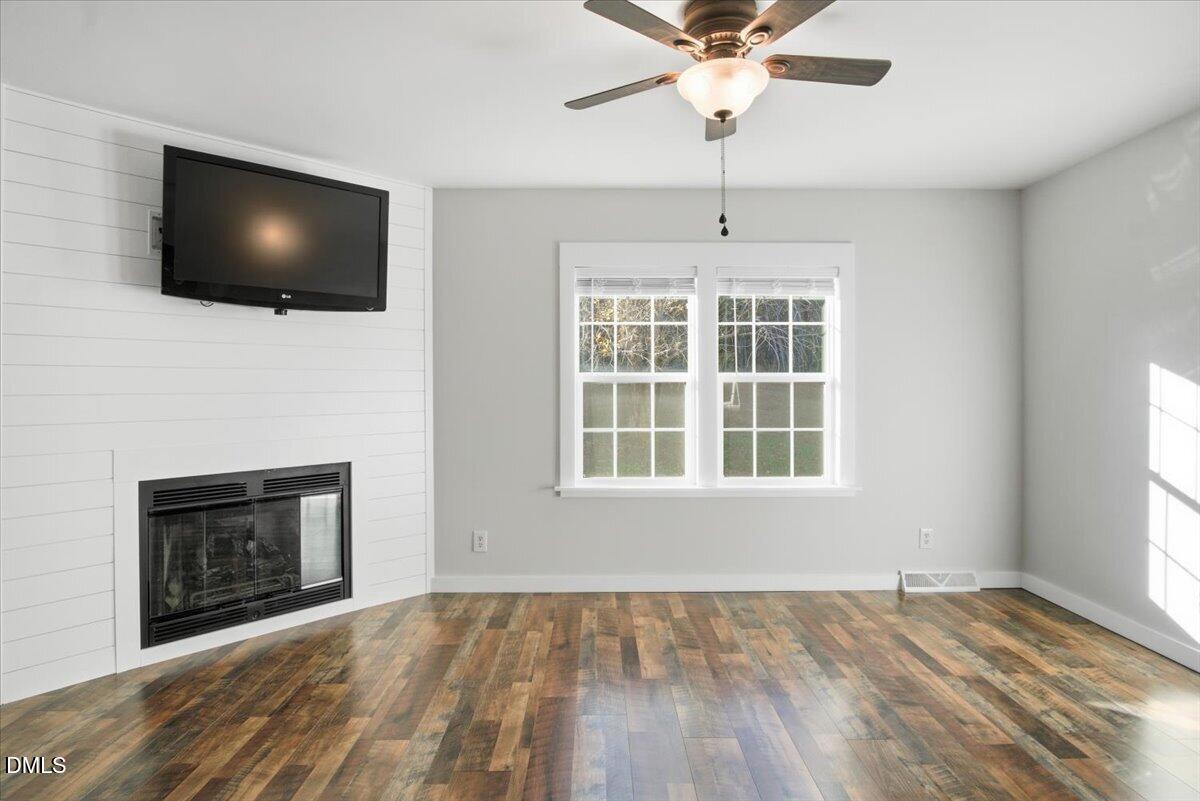 287 Moss Stock Farm Road Kittrell, NC 27544 - Photo 12 of 54 a flat screen tv on a table and a fireplace