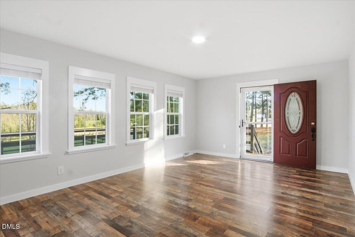 287 Moss Stock Farm Road Kittrell, NC 27544 - Photo 15 of 54 a view of an empty room with wooden floor and a window