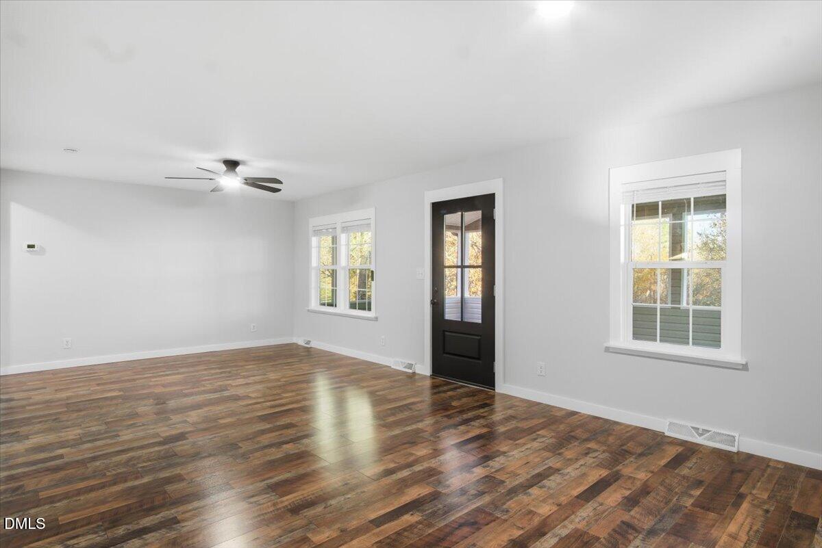 287 Moss Stock Farm Road Kittrell, NC 27544 - Photo 16 of 54 a view of an empty room with a window and wooden floor