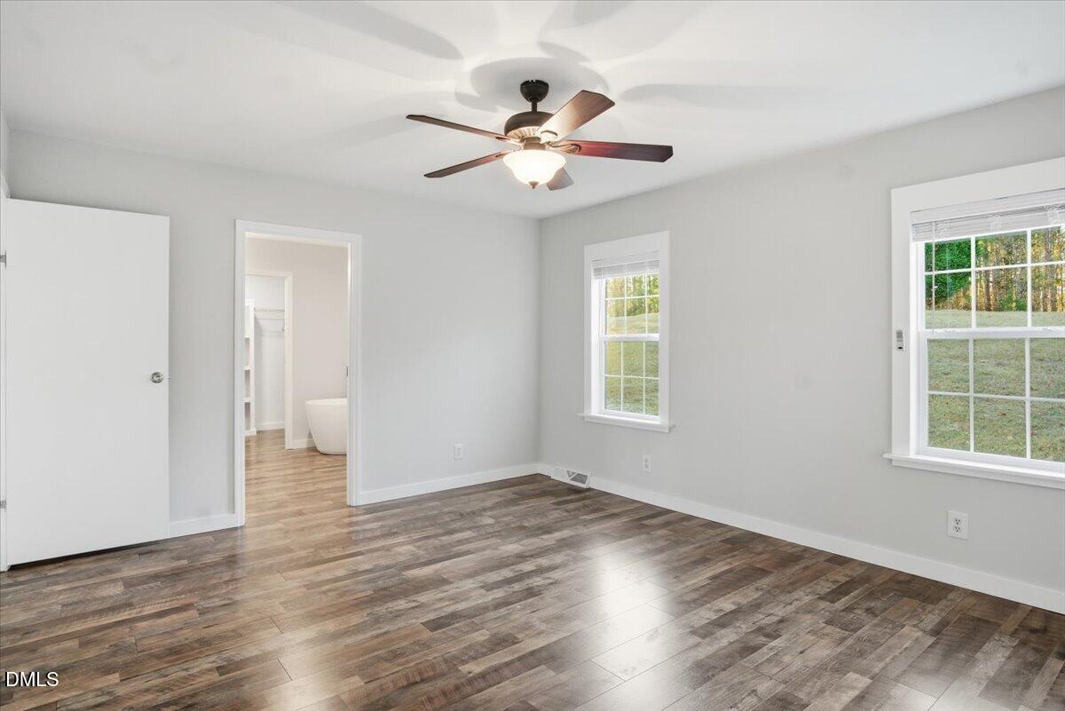 287 Moss Stock Farm Road Kittrell, NC 27544 - Photo 18 of 54 a view of an empty room with wooden floor and a window