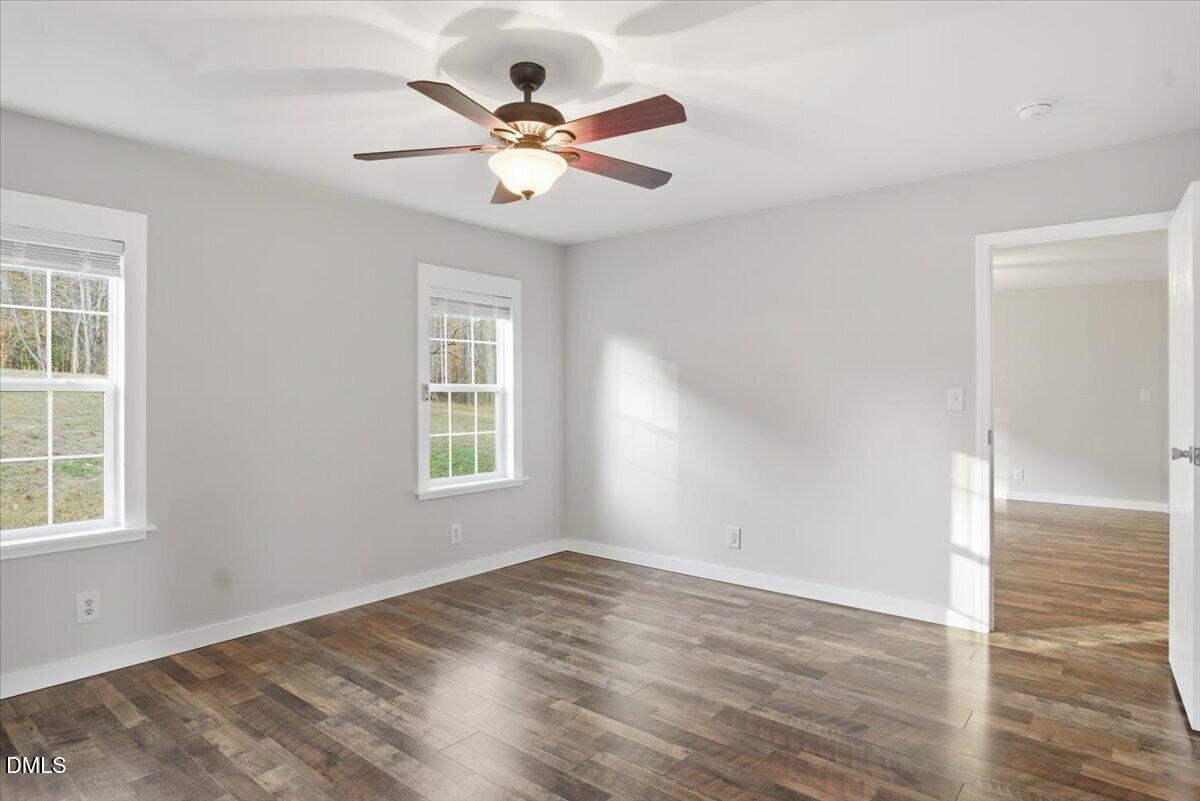 287 Moss Stock Farm Road Kittrell, NC 27544 - Photo 19 of 54 an empty room with wooden floor and windows