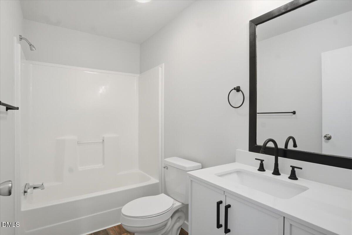 287 Moss Stock Farm Road Kittrell, NC 27544 - Photo 23 of 54 a bathroom with a sink a toilet and shower