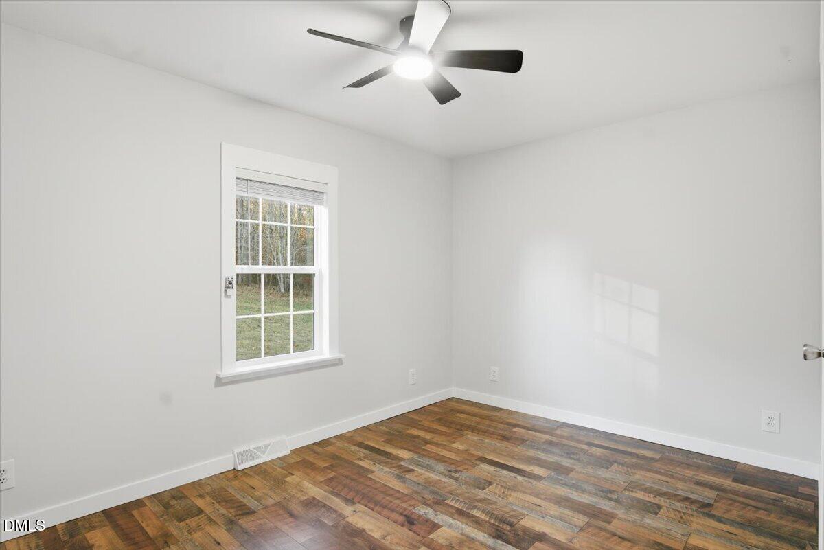 287 Moss Stock Farm Road Kittrell, NC 27544 - Photo 27 of 54 an empty room with wooden floor and windows