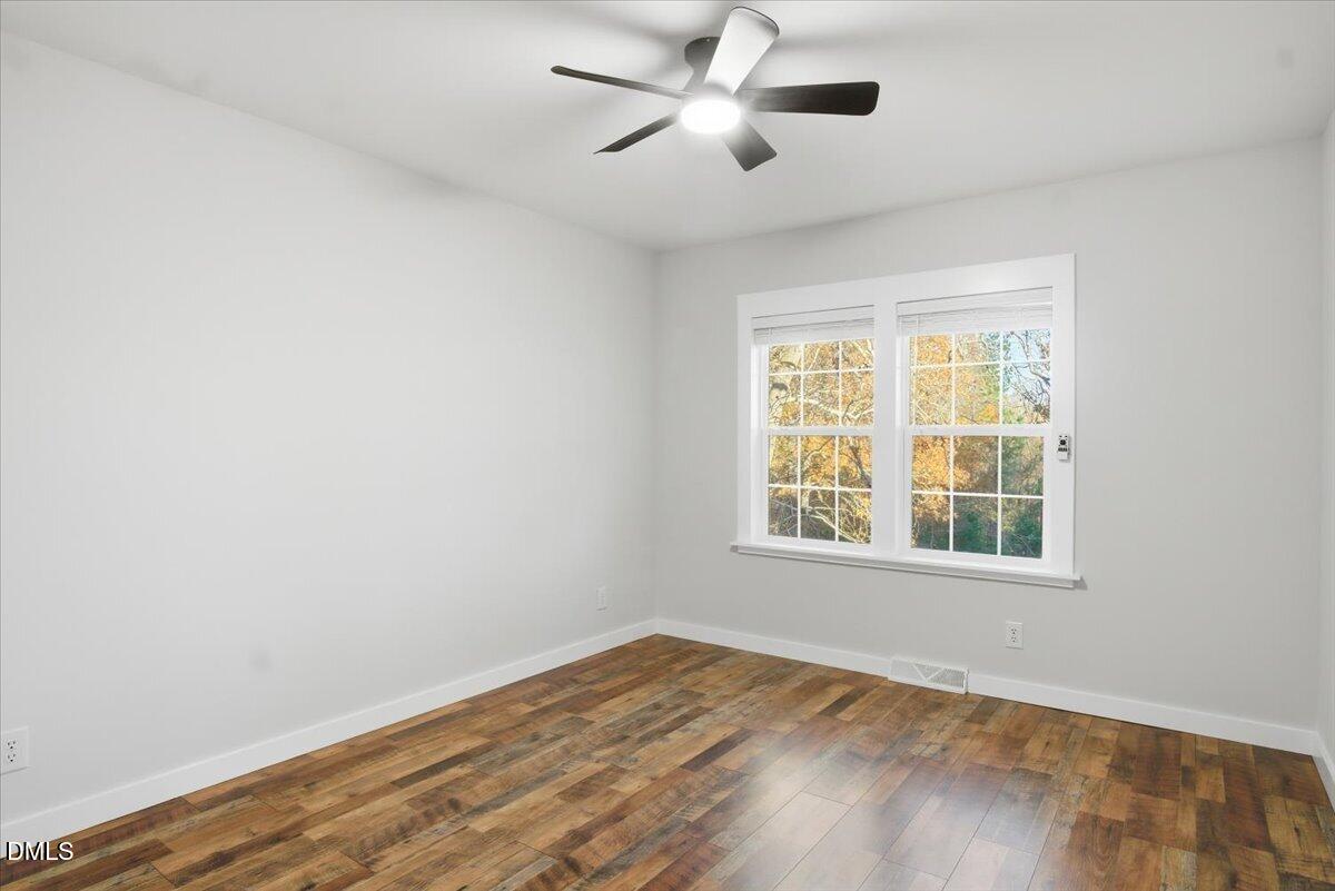 287 Moss Stock Farm Road Kittrell, NC 27544 - Photo 29 of 54 a view of empty room with wooden floor and fan