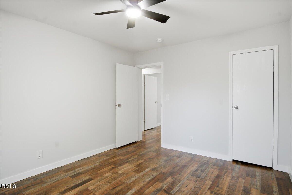287 Moss Stock Farm Road Kittrell, NC 27544 - Photo 30 of 54 an empty room with wooden floor and windows