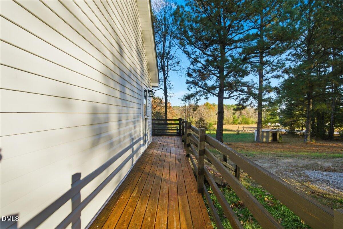 287 Moss Stock Farm Road Kittrell, NC 27544 - Photo 38 of 54 a view of balcony with wooden floor and trees