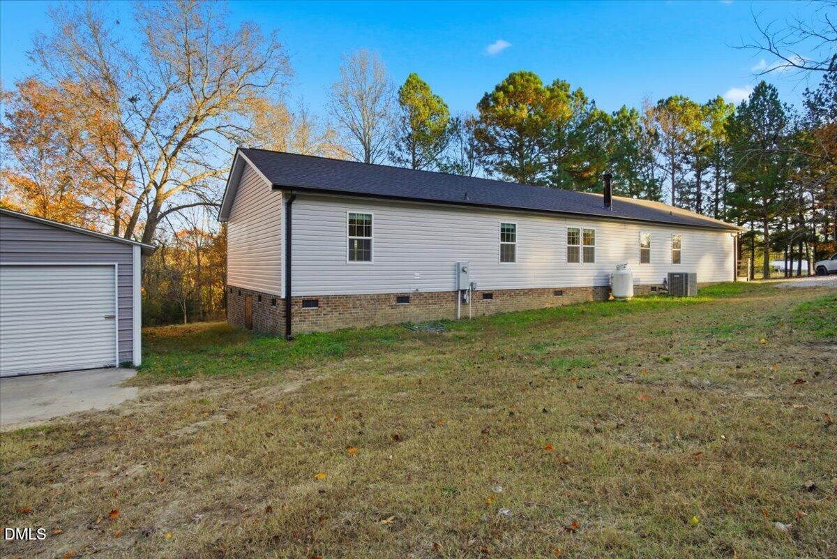 287 Moss Stock Farm Road Kittrell, NC 27544 - Photo 39 of 54 a backyard of a house with plants and large tree