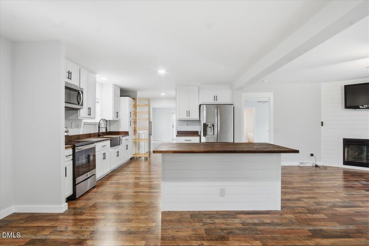 287 Moss Stock Farm Road Kittrell, NC 27544 - Photo 8 of 54 a large kitchen with granite countertop a stove top oven a sink a counter space and cabinets