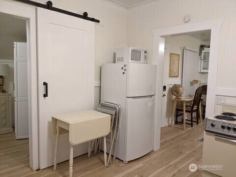 4106 Pacific Way Seaview, WA 98644 - Photo 13 of 21 a white refrigerator freezer and a table in a kitchen