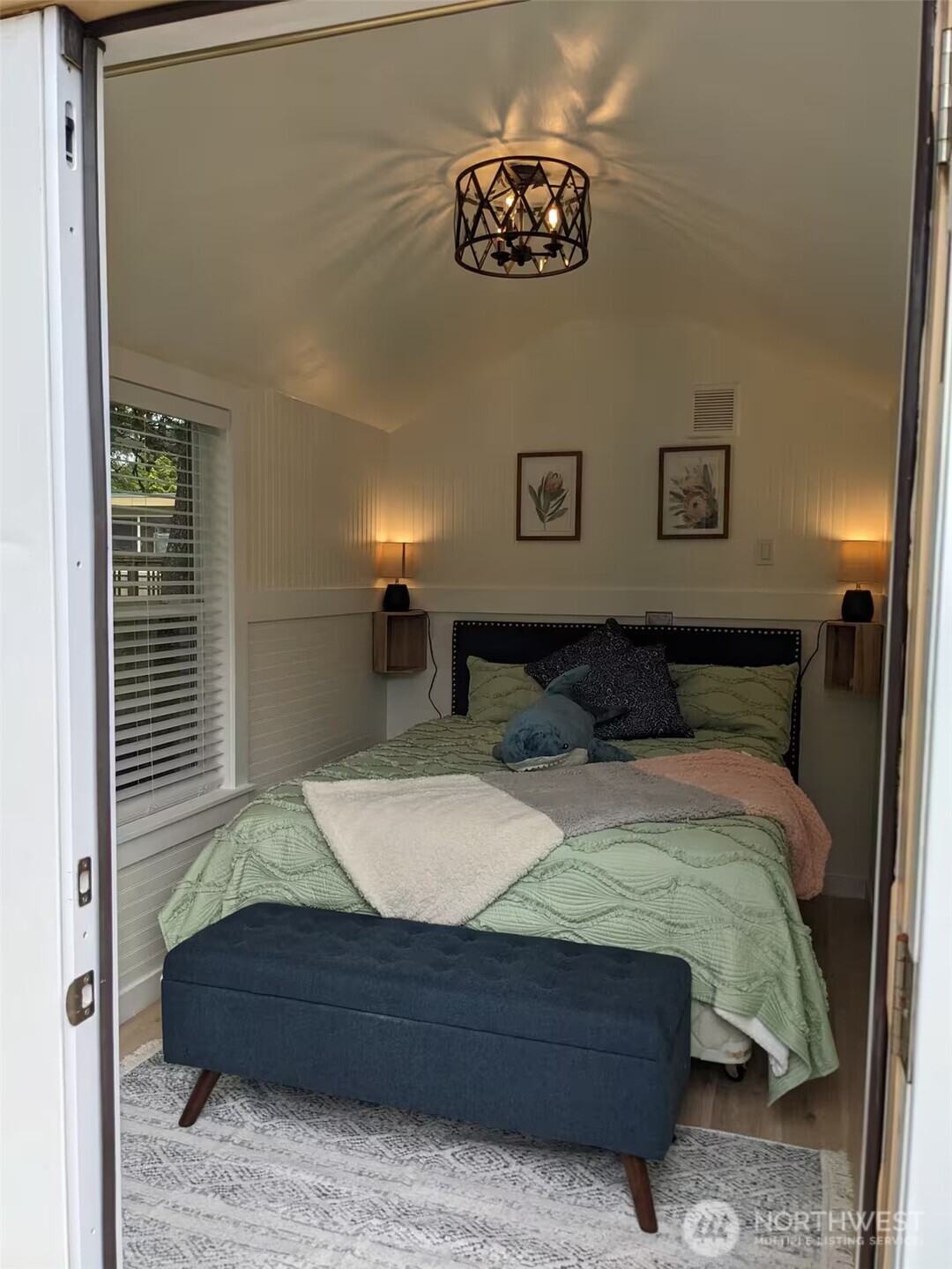 4106 Pacific Way Seaview, WA 98644 - Photo 18 of 21 a bed sitting in a bedroom and painting on the wall