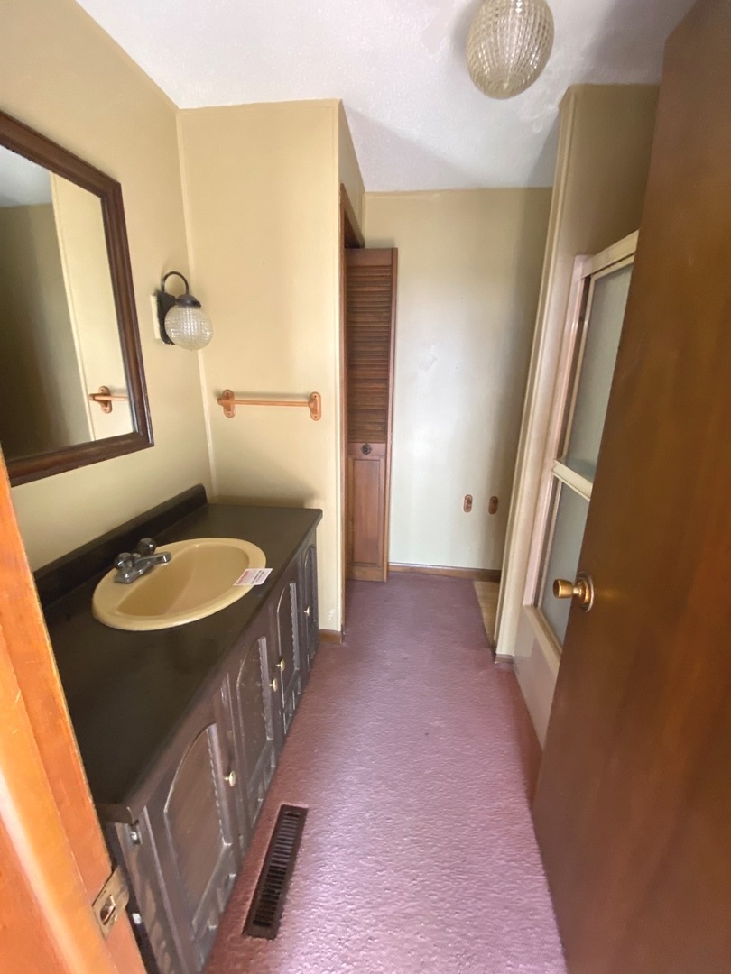 404 North Main Coleta, IL 61081 - Photo 24 of 32 a bathroom with sink shower and mirror