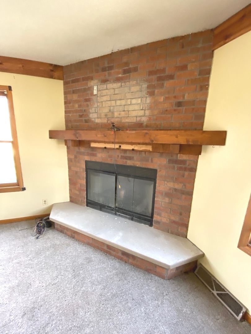 404 North Main Coleta, IL 61081 - Photo 3 of 32 a living room with a fireplace