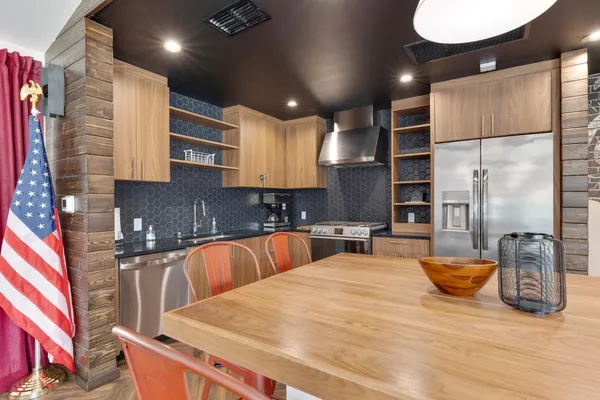 a kitchen with stainless steel appliances kitchen island granite countertop a sink and cabinets