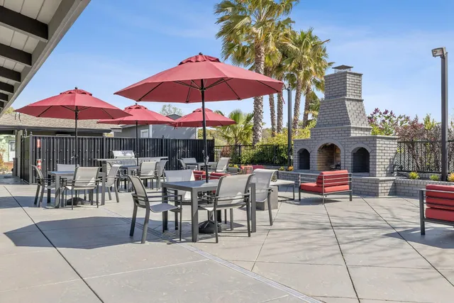 a view of a tables and chairs under an umbrella