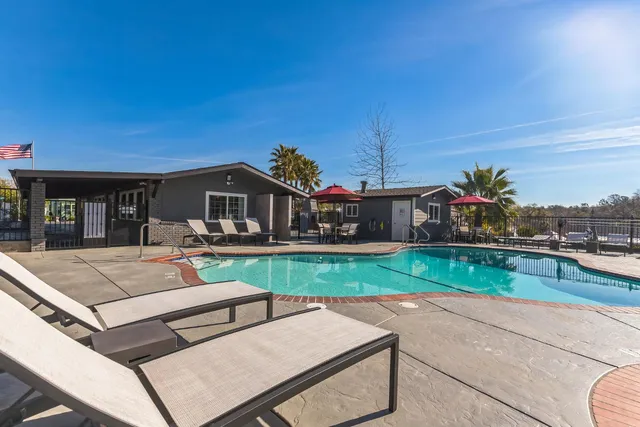 a view of house with outdoor space and sitting area