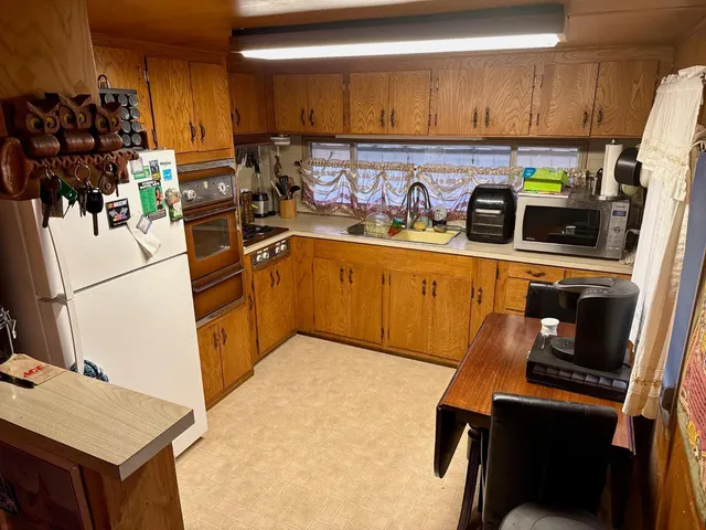 a kitchen with stainless steel appliances a sink a refrigerator and a stove