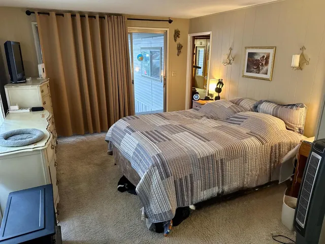 a bedroom with a bed and a couch