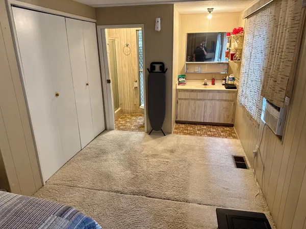a bathroom with a sink a mirror and a bath tub
