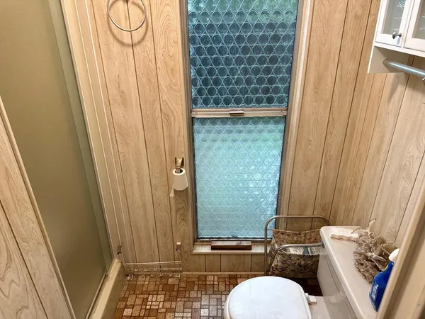 a bathroom with a toilet a sink and a shower