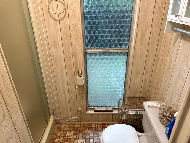 a bathroom with a toilet a sink and a shower