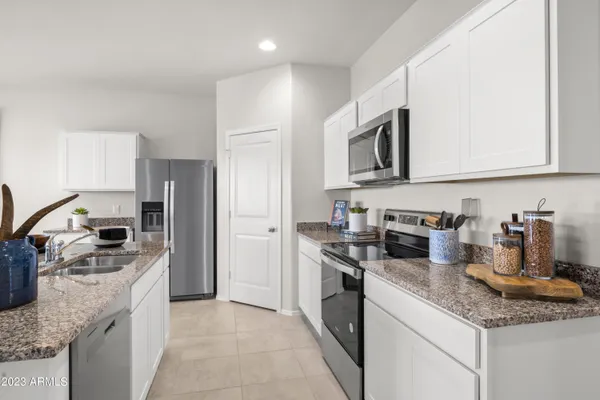 a kitchen with stainless steel appliances granite countertop a sink stove oven and refrigerator