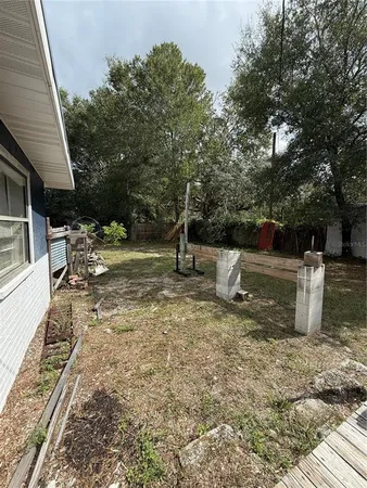 a view of a house with a yard and sitting area