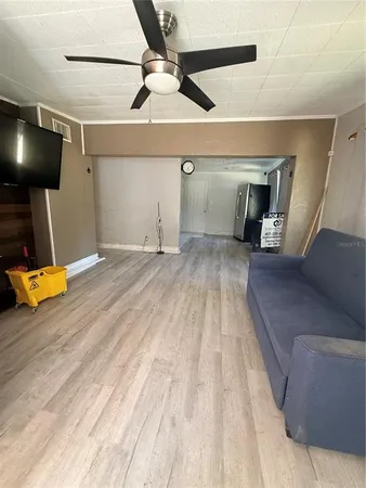 a view of kitchen with stainless steel appliances wooden floor and a counter top space