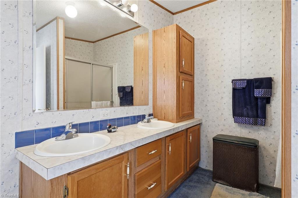 4790 Waynick Meadow Road Asheboro, NC 27205 - Photo 17 of 33 Ensuite primary bathroom with double vanity and tub.
