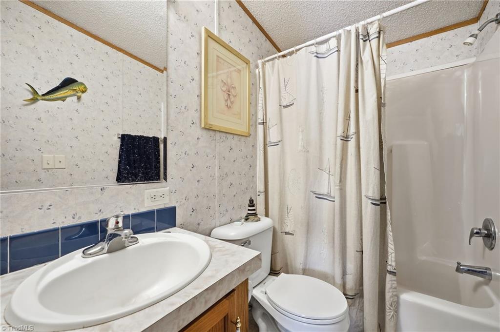 4790 Waynick Meadow Road Asheboro, NC 27205 - Photo 21 of 33 Separate full bathroom with single vanity and shower & tub combo near the second and third bedroom.