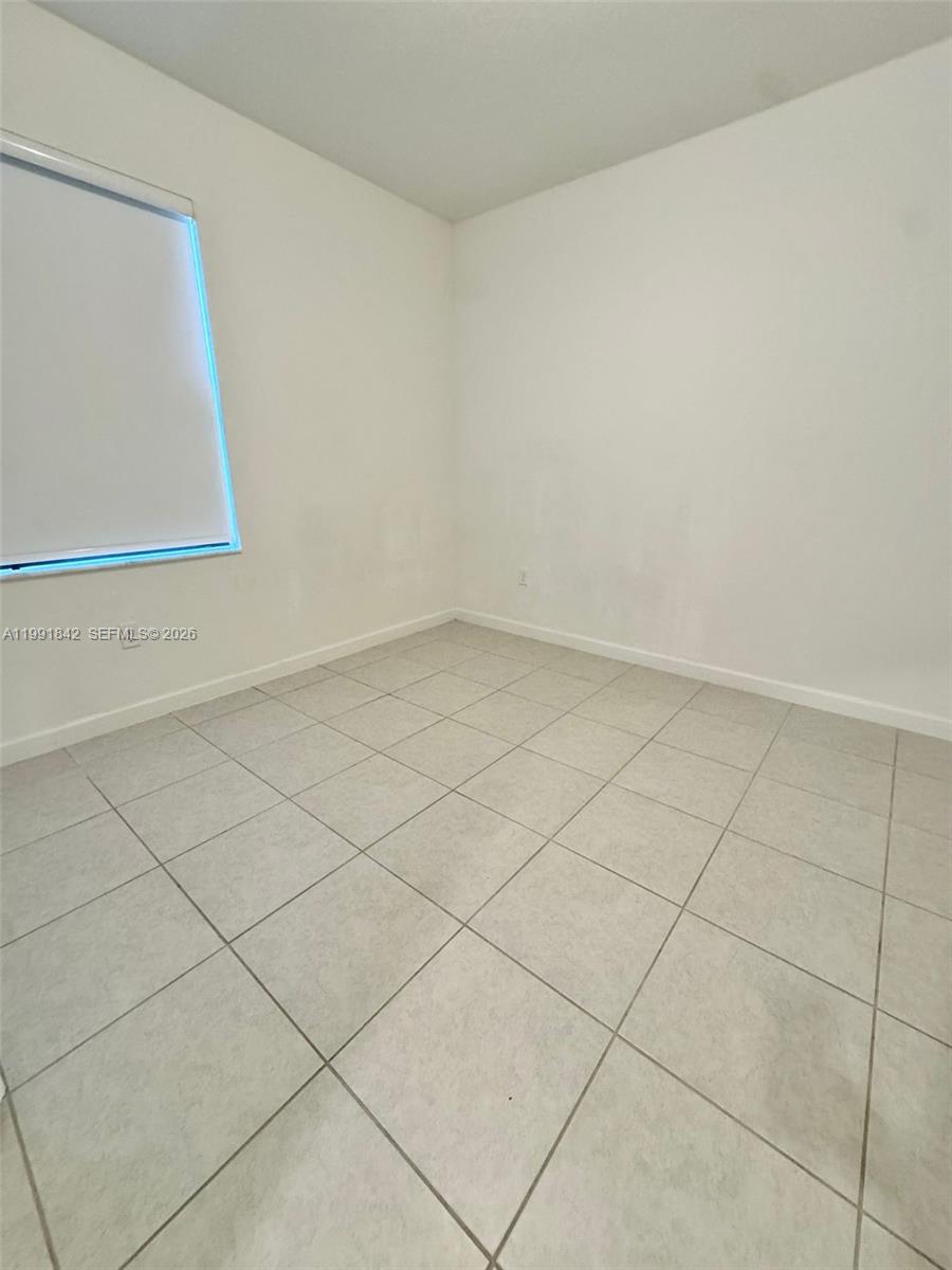 12986 Southwest 232nd Terrace, Unit 12986 Homestead, FL 33032 - Photo 8 of 11 a view of white wall