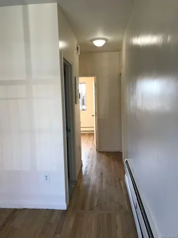 a view of hallway with wooden floor