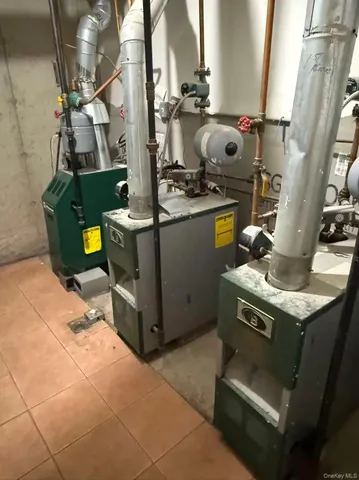 a room with stainless steel appliances kitchen island granite countertop a stove and a sink