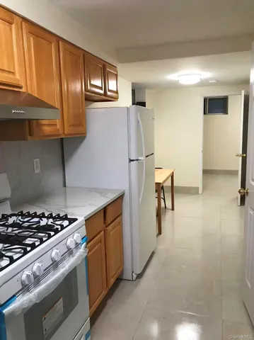 a kitchen with a stove a refrigerator and cabinets