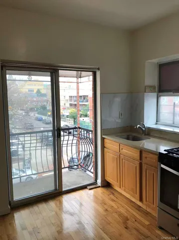 a kitchen with stainless steel appliances granite countertop a stove a sink and a microwave