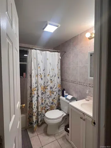 a bathroom with a toilet a sink and shower