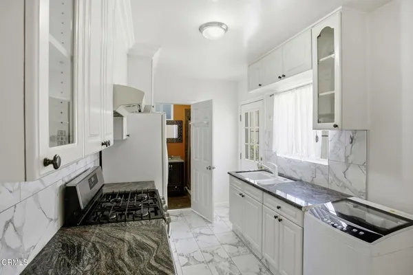 a kitchen that has a sink and a stove