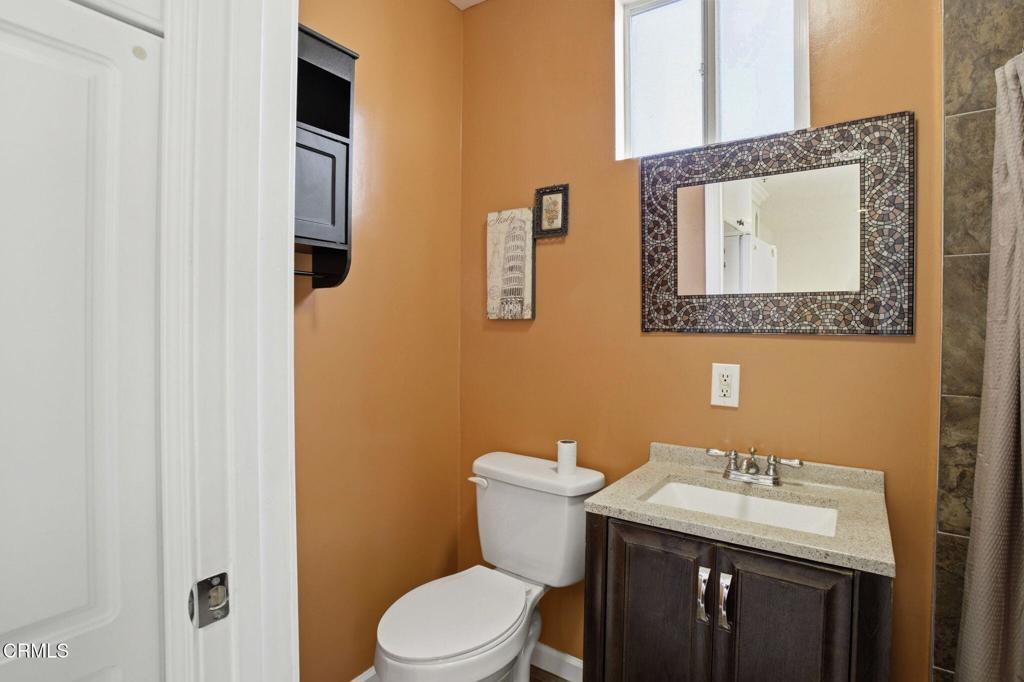1606 Glenwood Road, Unit A Glendale, CA 91201 - Photo 22 of 28 a bathroom with a sink a toilet and mirror