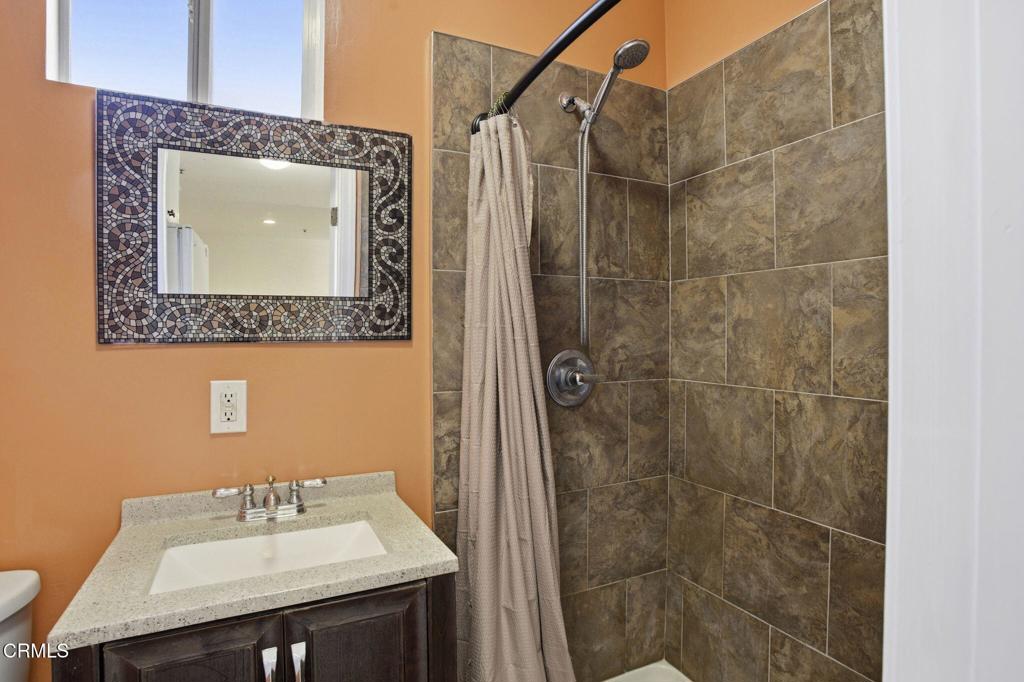 1606 Glenwood Road, Unit A Glendale, CA 91201 - Photo 23 of 28 a bathroom with a sink mirror and shower