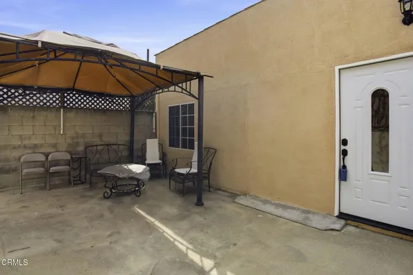 a backyard of a house with table and chairs