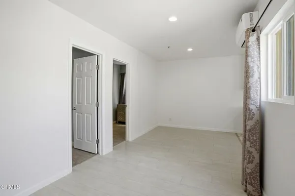 an empty room with windows and closet