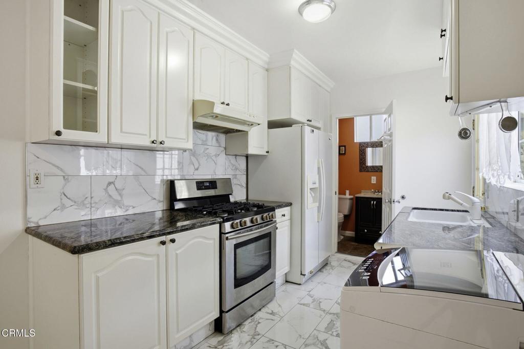 1606 Glenwood Road, Unit A Glendale, CA 91201 - Photo 10 of 28 a kitchen with granite countertop a sink a stove and refrigerator