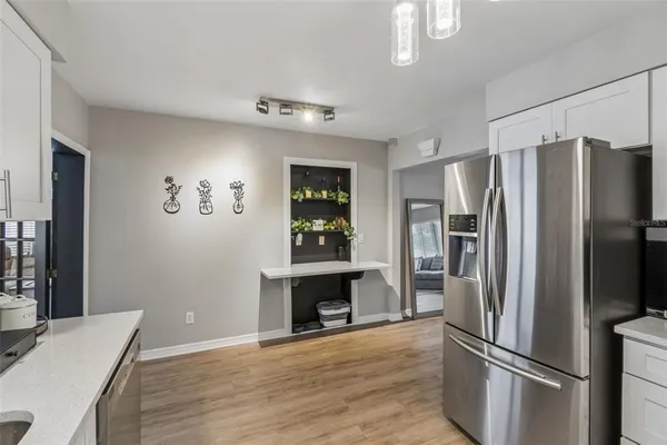 a kitchen with stainless steel appliances a refrigerator sink and cabinets