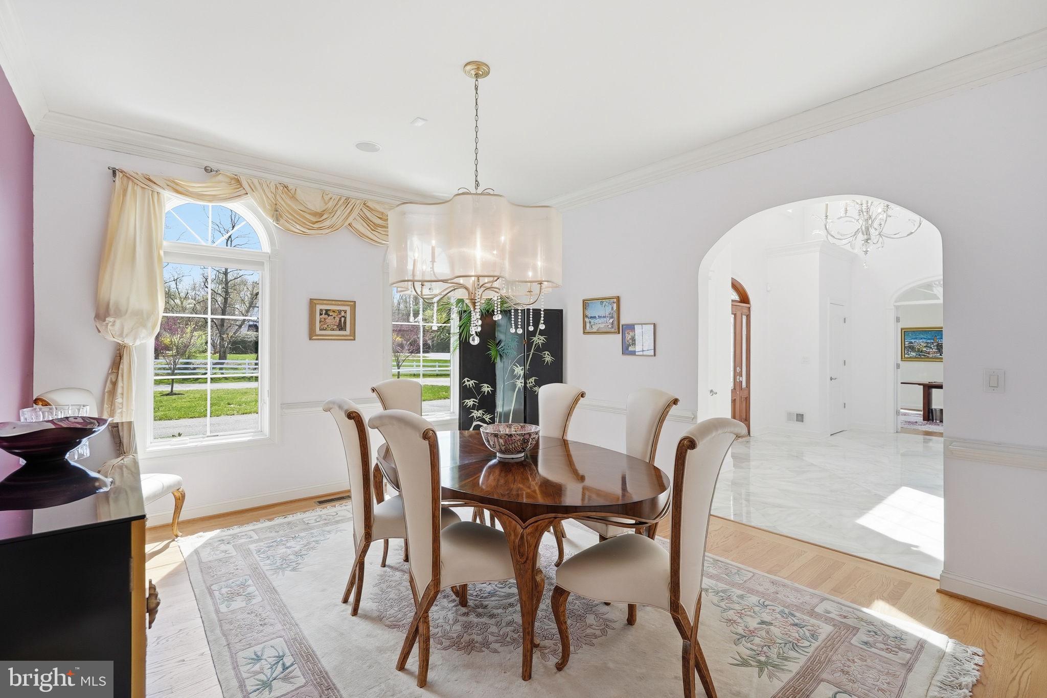 10708 Lockland Road Potomac, MD 20854 - Photo 25 of 69 a view of a dining room and livingroom with furniture wooden floor a chandelier